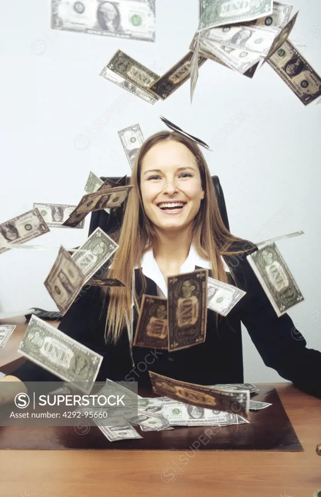 Woman with money flying around her