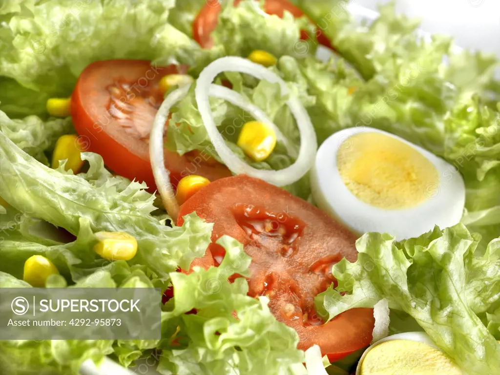 Salad with tomatoes onions, corn and boiled eggs
