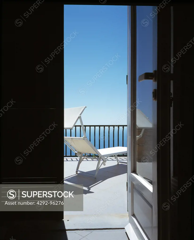 A balcony with deckchair