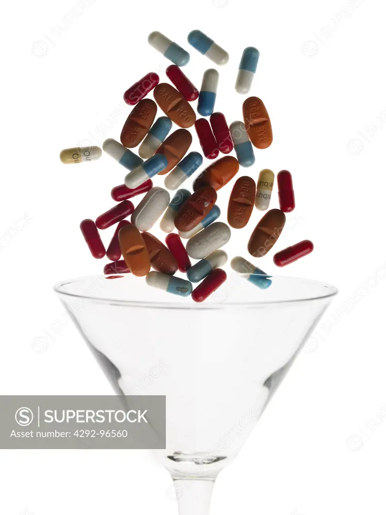 Pills falling in glass