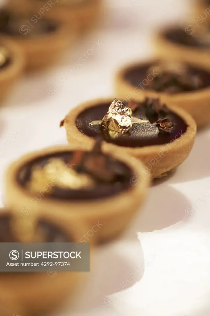 Tarts with chocolate and gold leaf