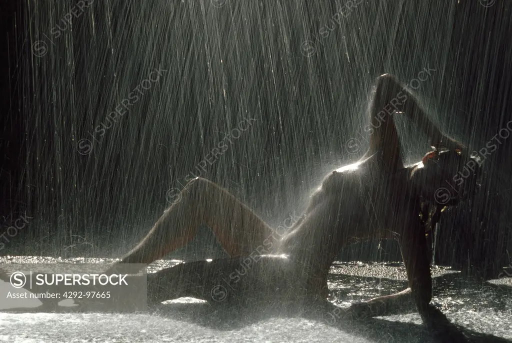 Nude woman under rain