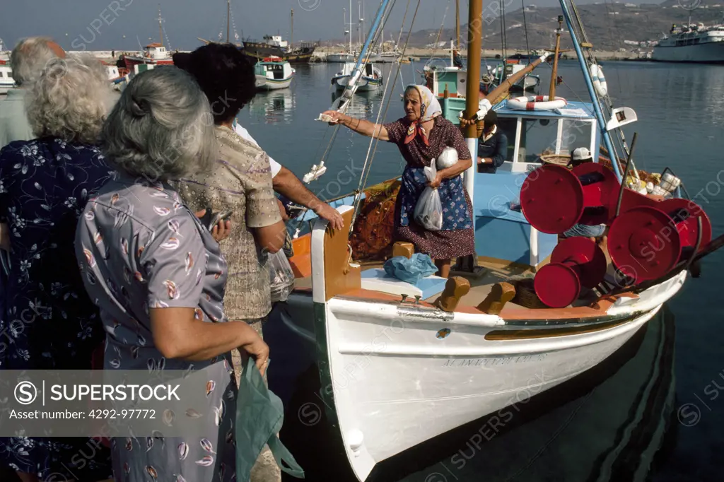 Greece, Cyclades islands, Mykonos,woman selling fish from fishing boat