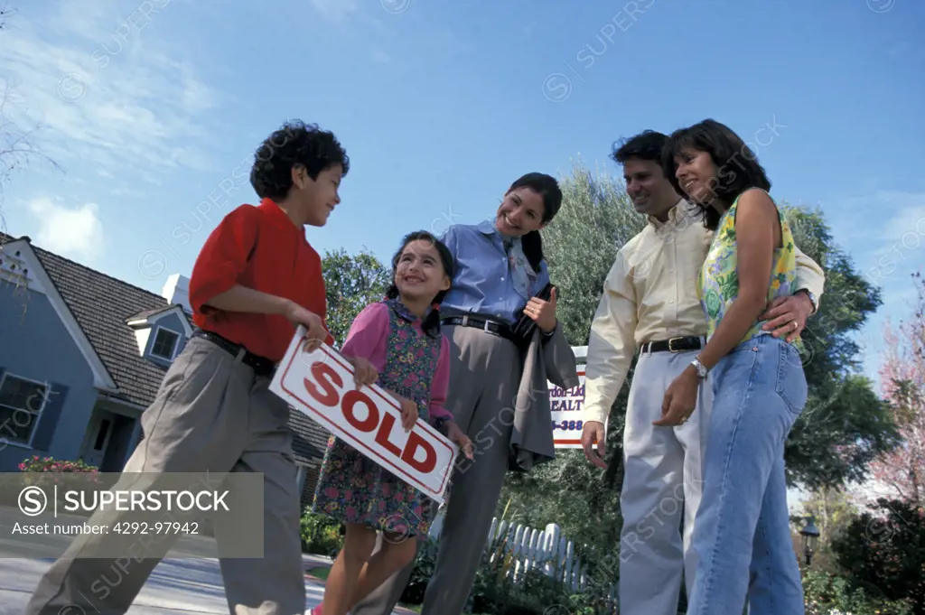 Family celebrating purchase of a new house