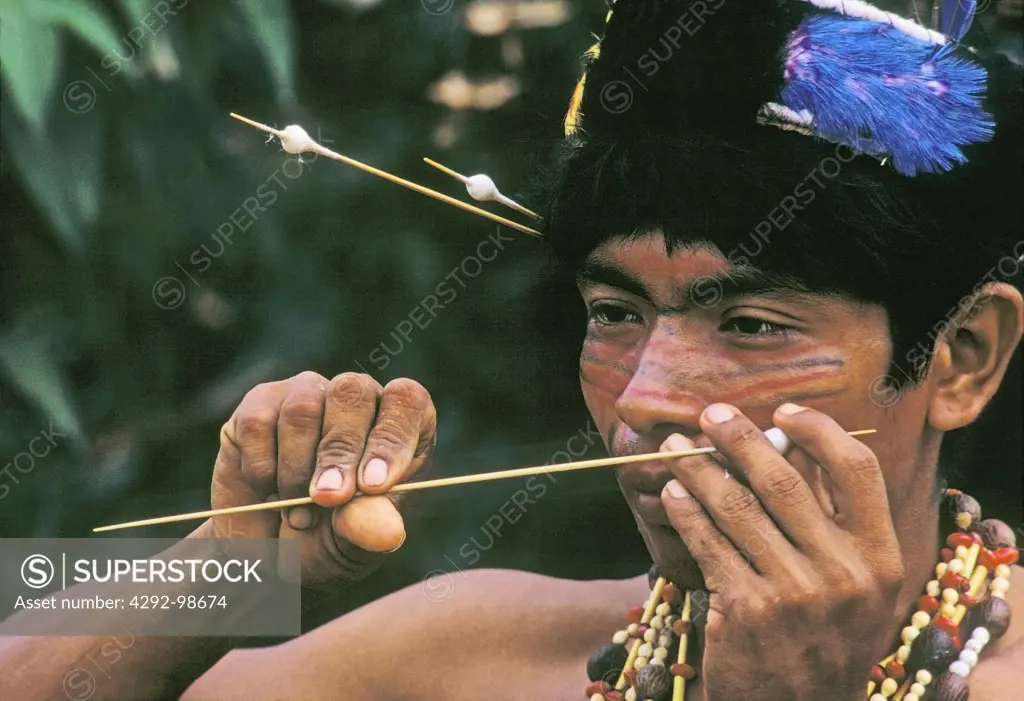 Amazonian Tribesman preparing a dart for hunting