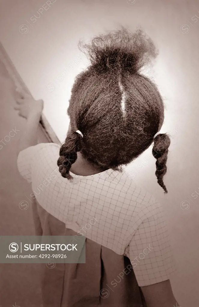 Afro-American girl with braided hair, back view