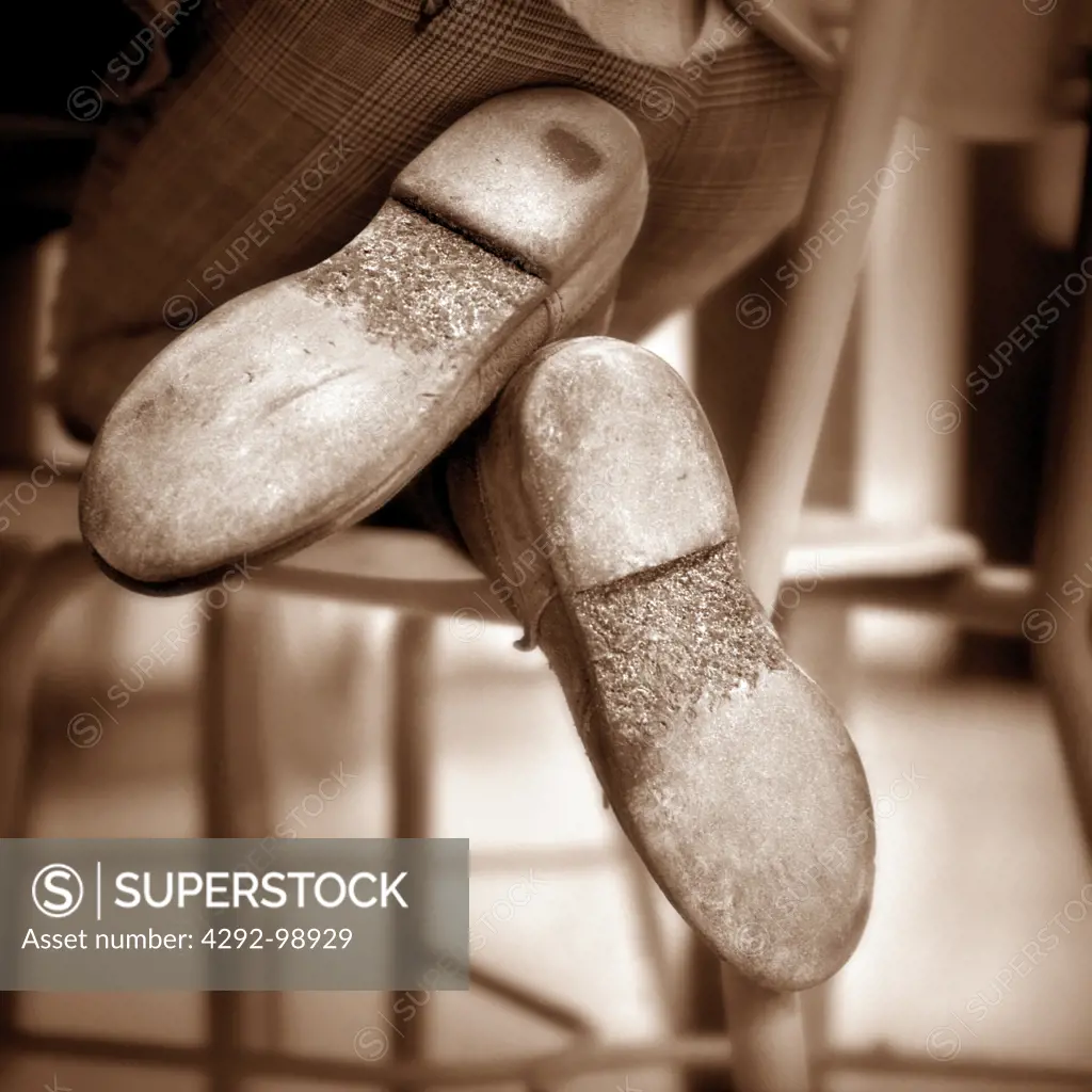 Young boy kneeling on a school class room chair