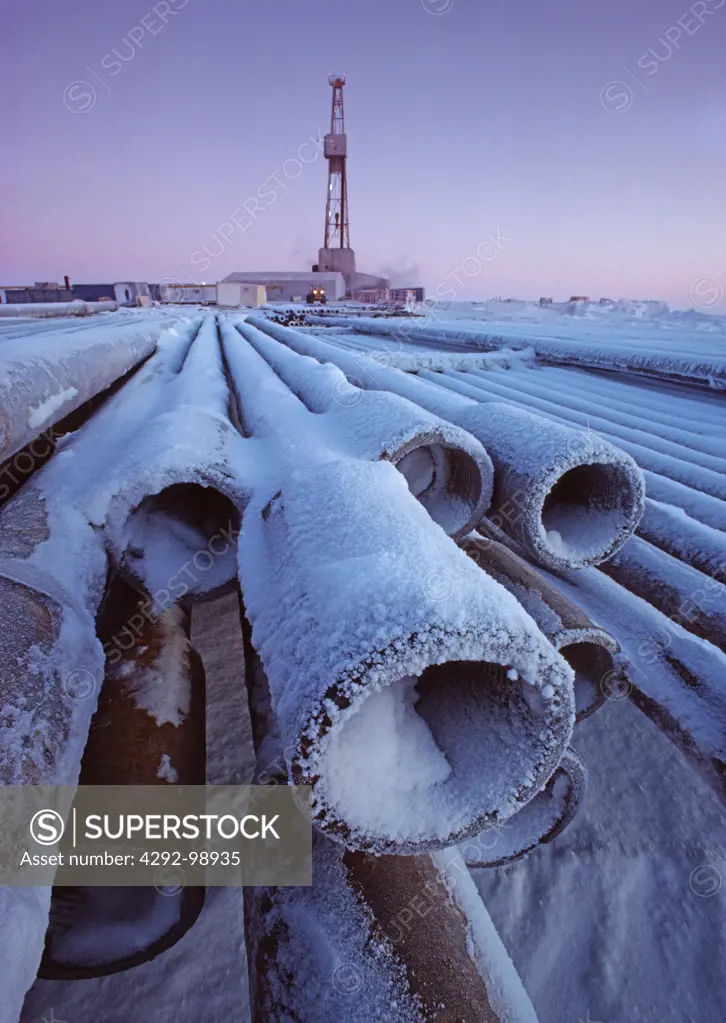 Snow covered drill pipe casings, oil well, Prudhoe Bay, Alaska, USA