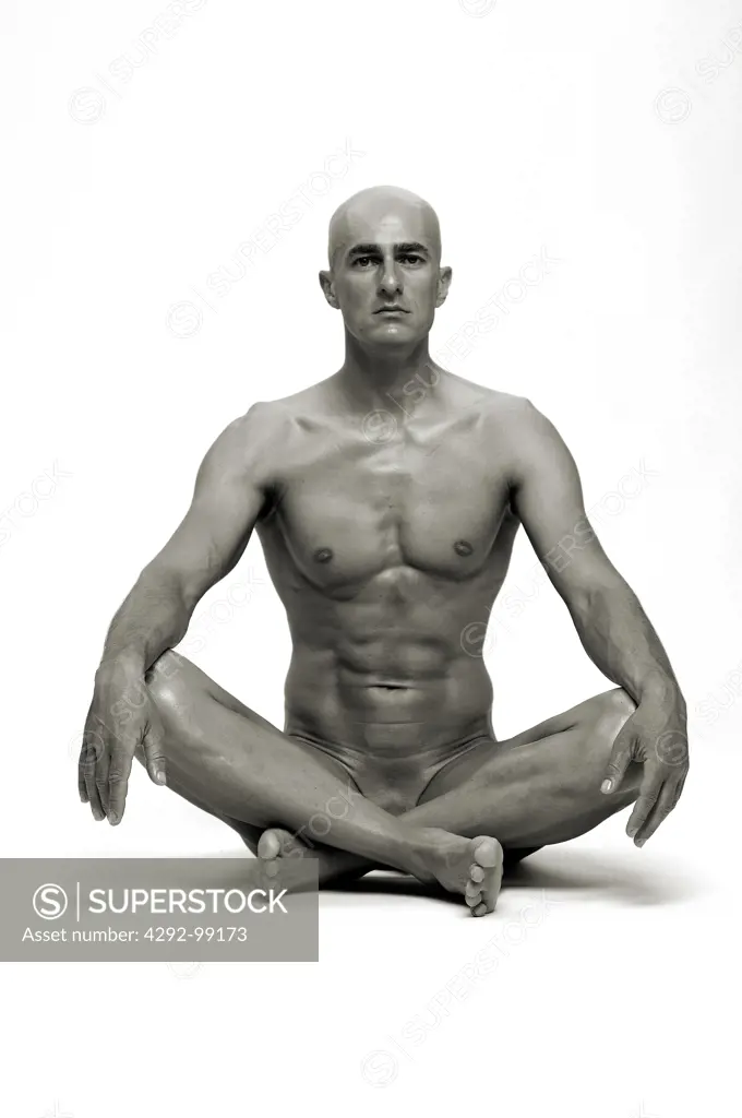 Naked man sitting on floor