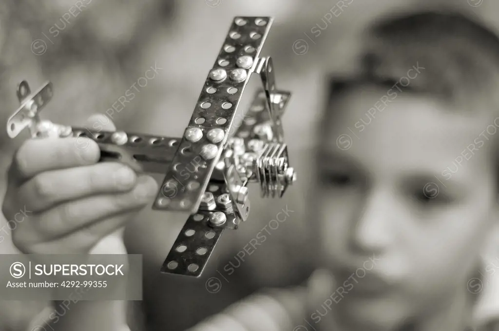Boy playing with model plane