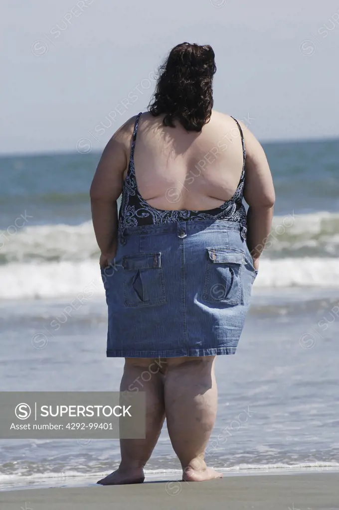 Rear view of a fat woman on the beach