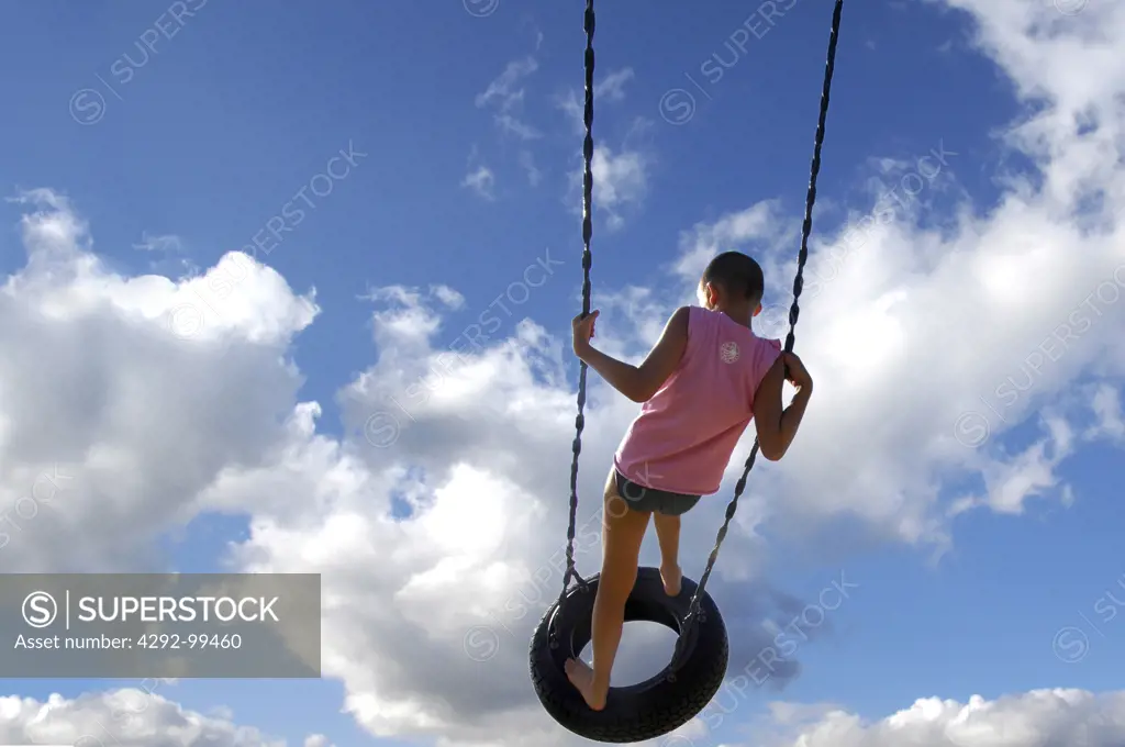 Boy on tire swing