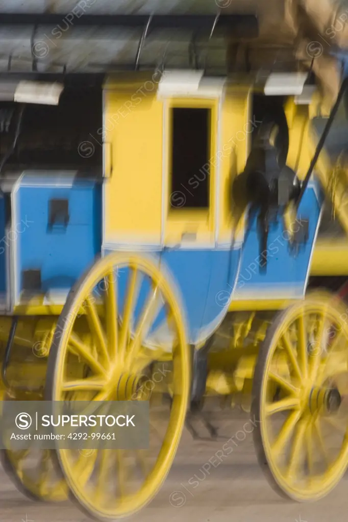 Antique wagon wheels turning during preparation for Tucson rodeo parade, USA