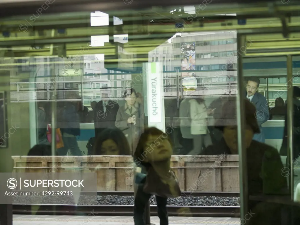 Japan, Tokyo. Commuters in railway station
