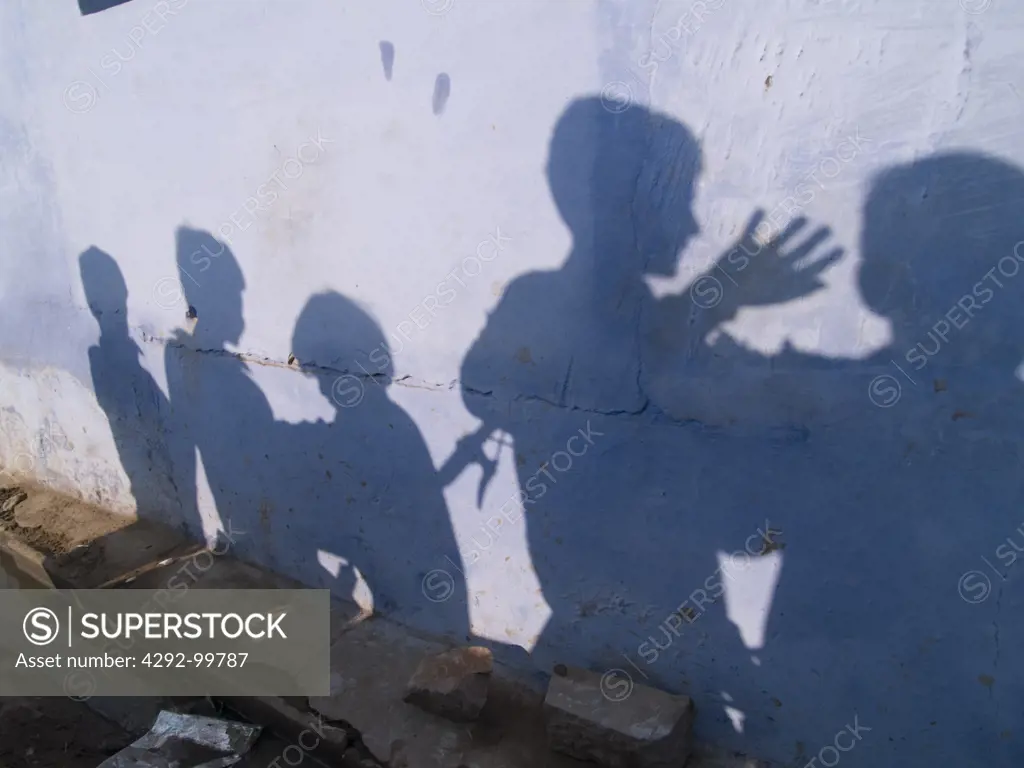 Kids playing with their shadow on a wall in Bundi, Rajasthan, India