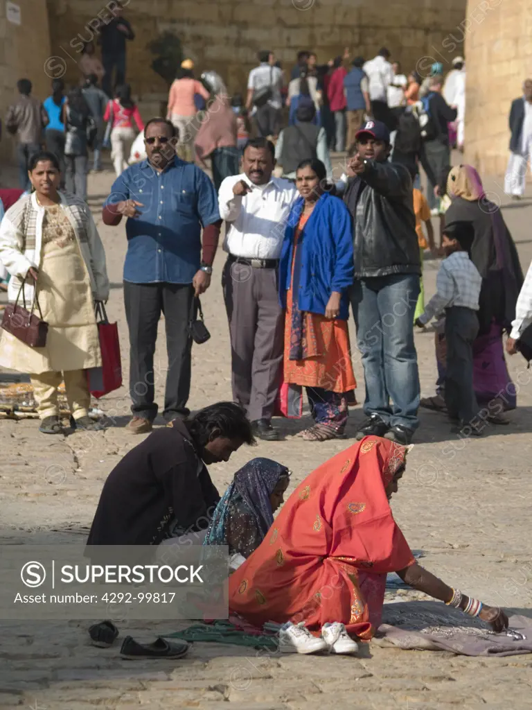 Indian tourists and local Indians selling jewelry near the fort in Jaisalmer, Rajasthan, India