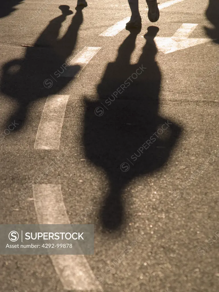 Shadow walking people on the street