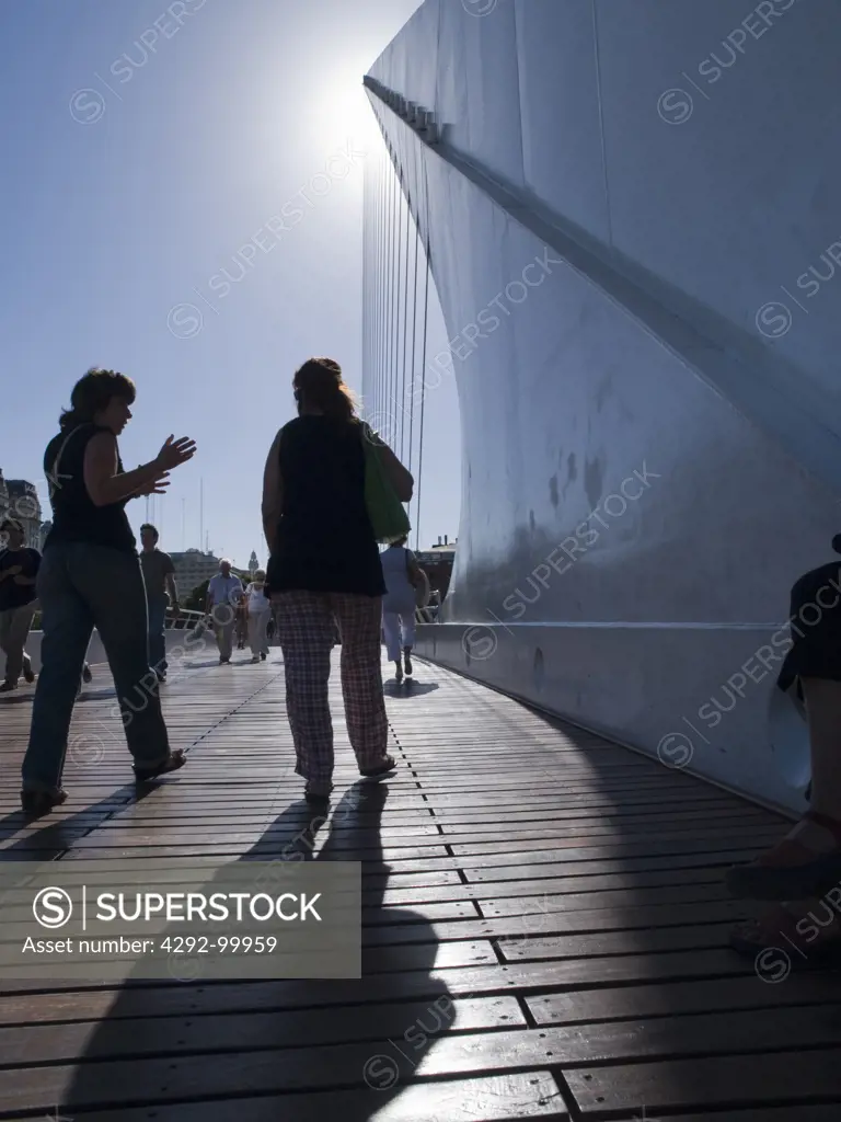 People walk on Santiago Calatrava's Puente De La Mujer (Bridge Of The Woman) in Buenos Aires, Argentina