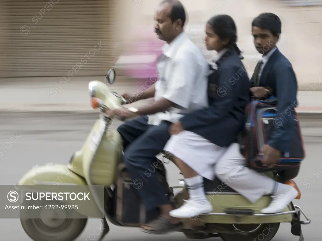 India, Karnataka, Bangalore, people on Vespa scooter