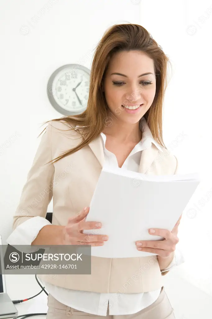 Businesswoman at office looking at documents