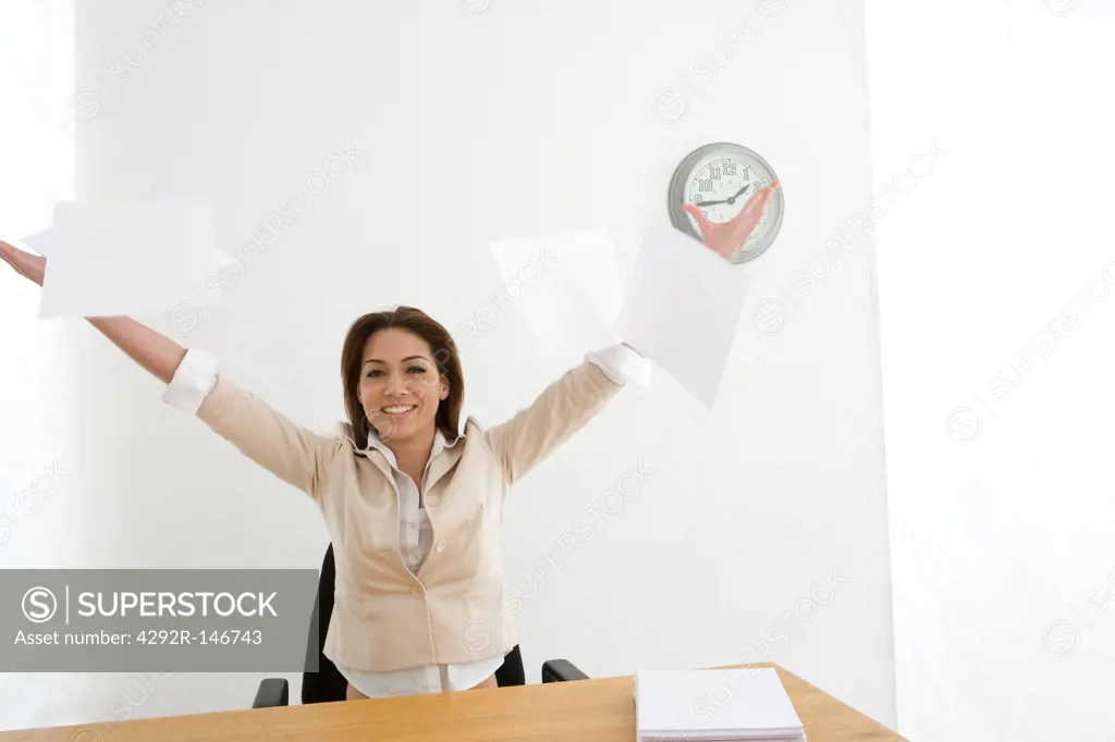 Businesswoman throwing office papers