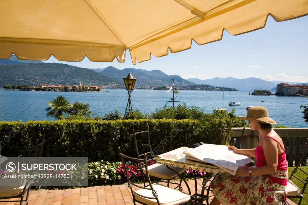 Italy, Piedmont, Stresa , woman on the terrace of hotel Villa Minta