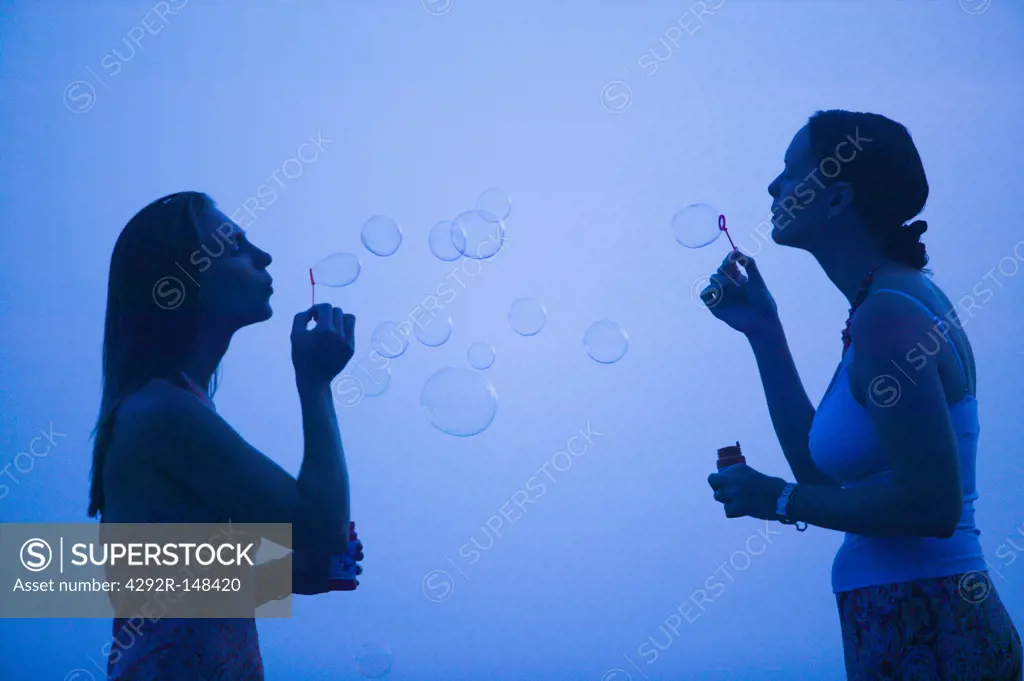 Women blowing bubbles