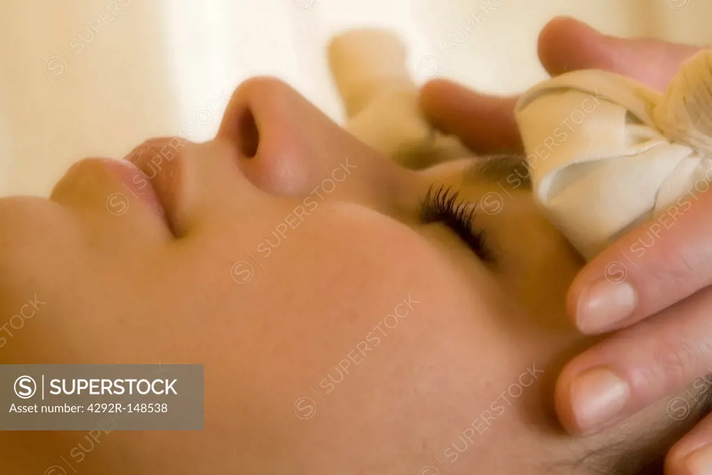 Woman at spa receiving a beauty treatment