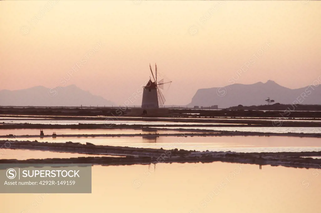 Italy, Sicily, Trapani. Salt ponds and windmill