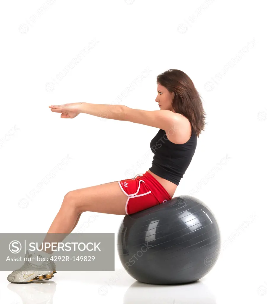Woman exercising with fitness ball,studio shot