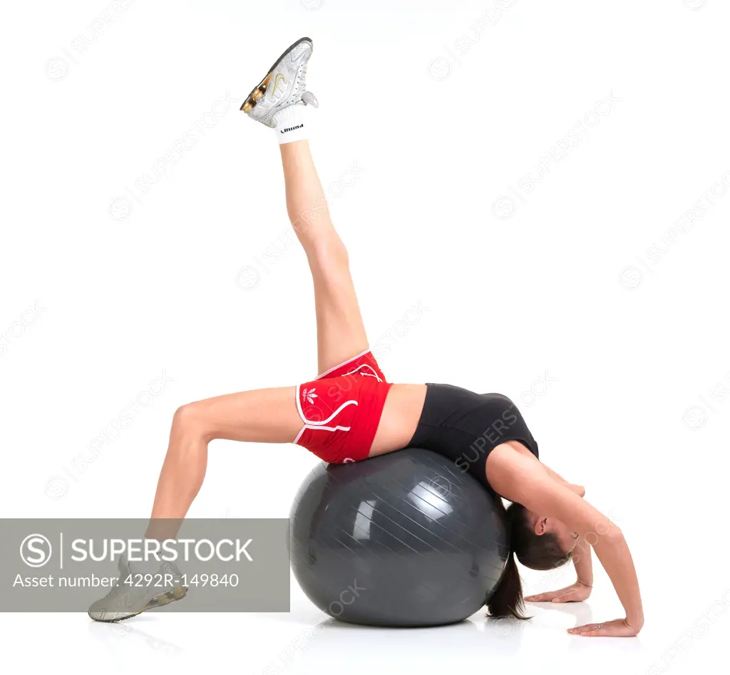 Woman exercising with fitness ball,studio shot