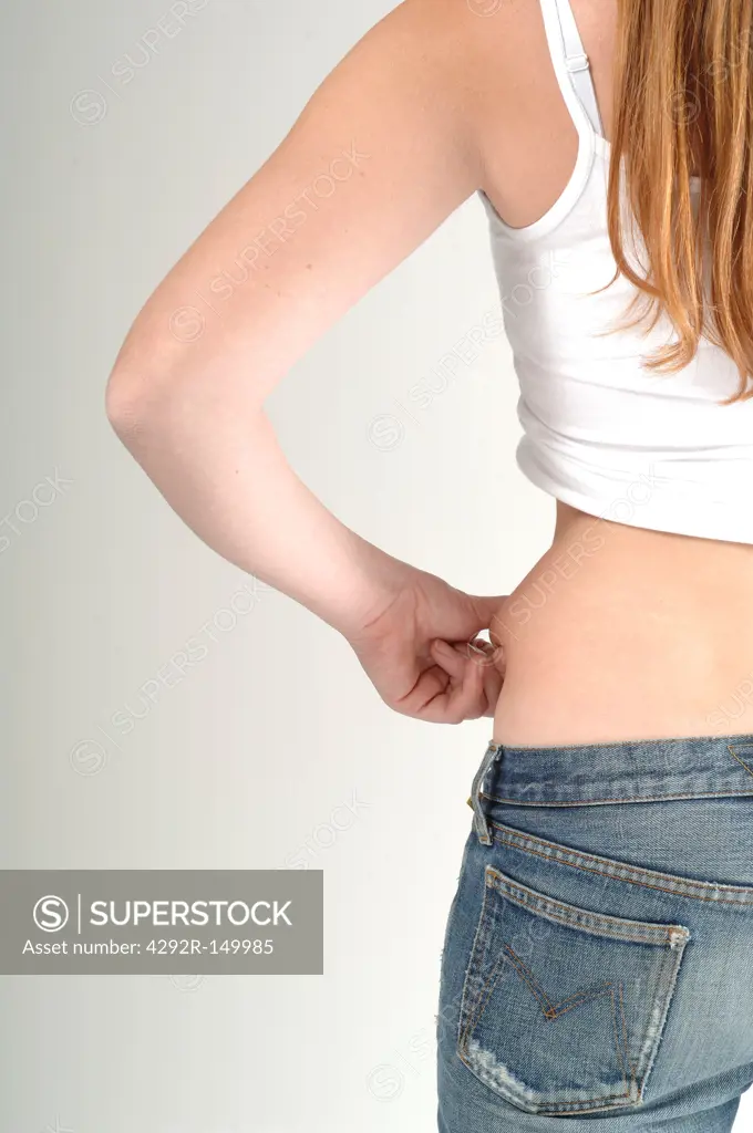 Woman pinching abdomen