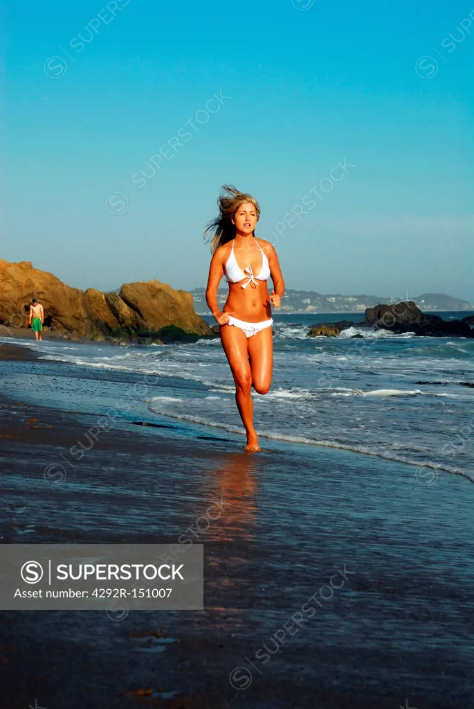 Woman runnig on the seashore
