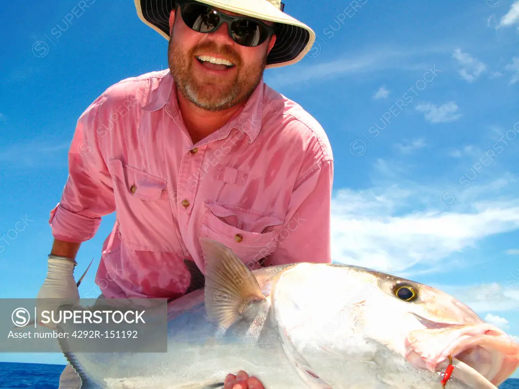 Fisherman with amberjack fish in Florida, USA