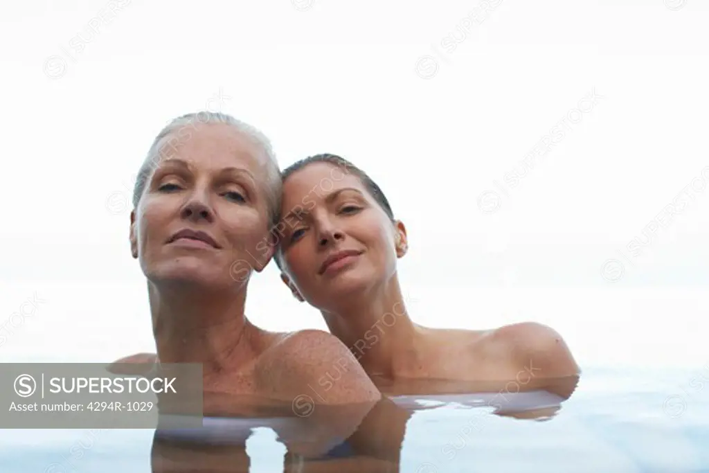 Two women relaxing in swimming pool