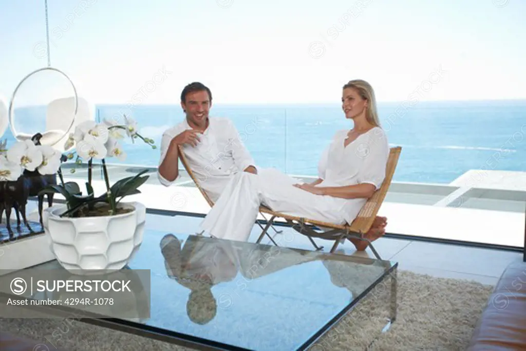 Couple in modern living room by the ocean