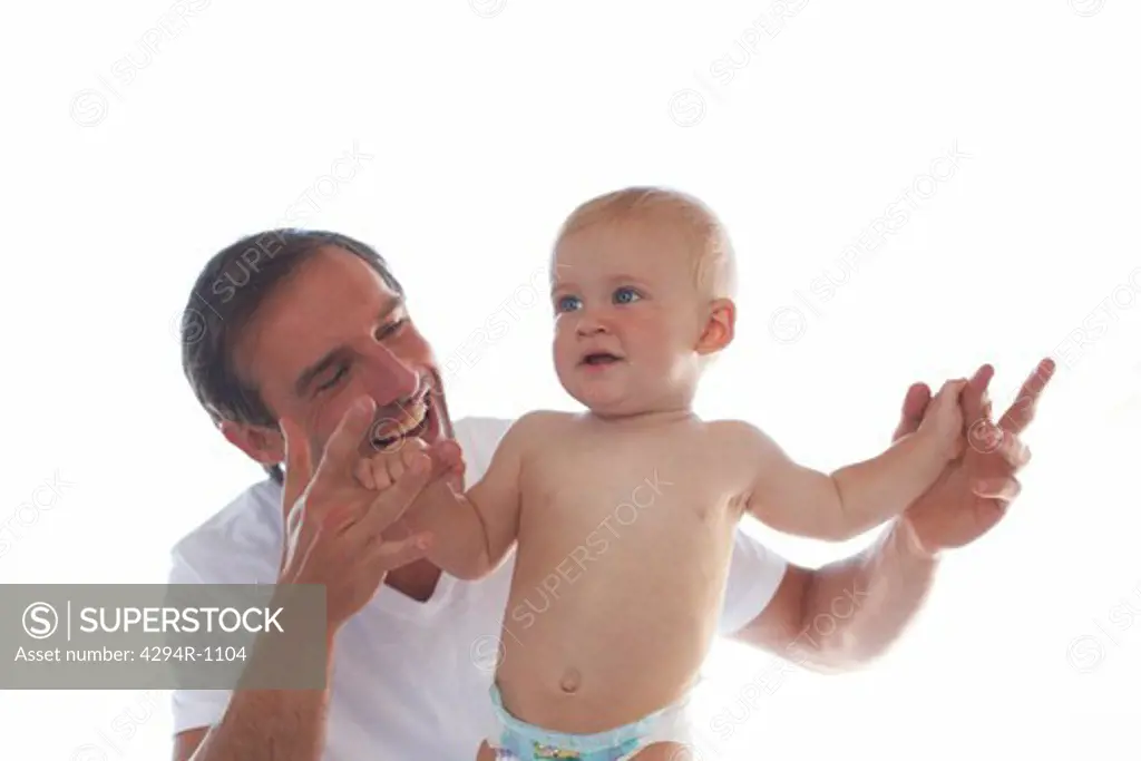 Happy father hand in hand with baby