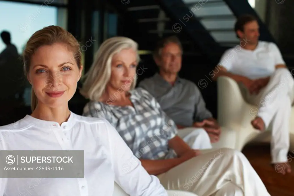 Woman sitting with parents and husband in the background