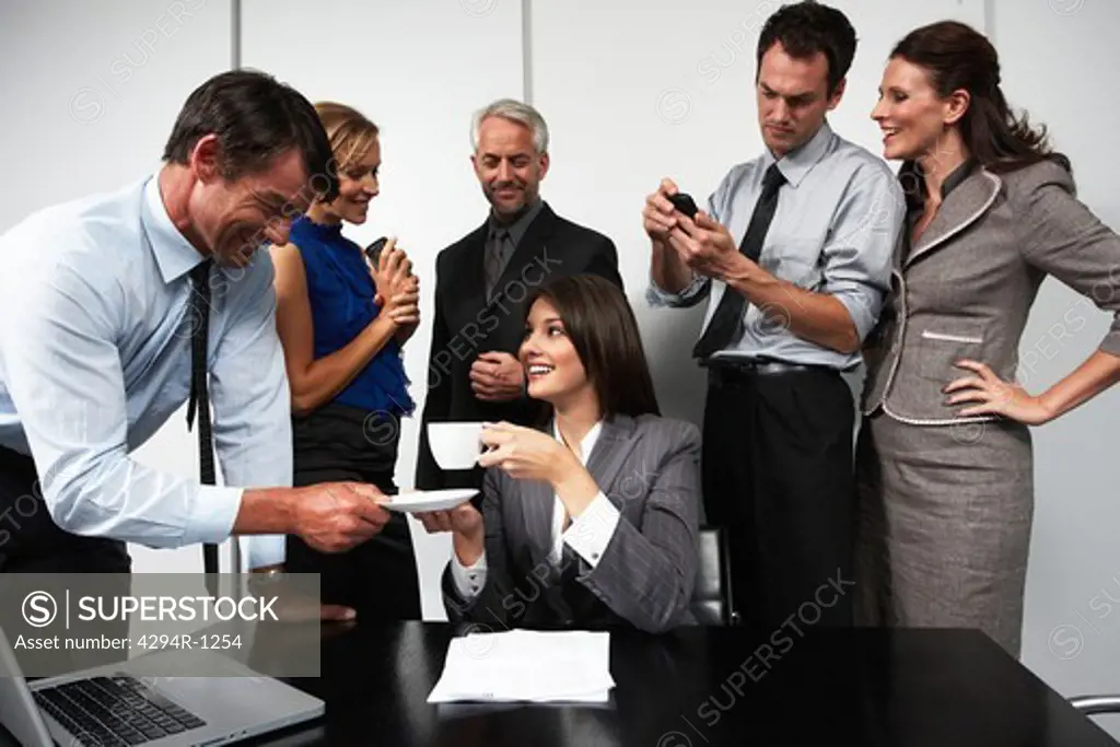 Businesswoman surrounded by businesspeople