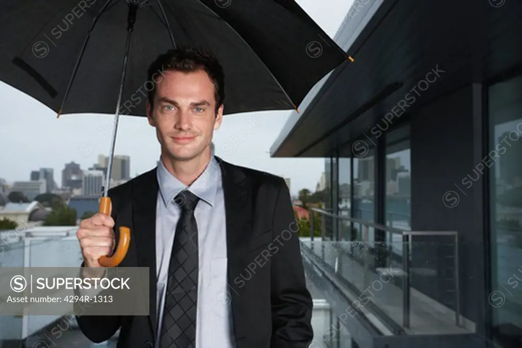 Businessman standing in the rain