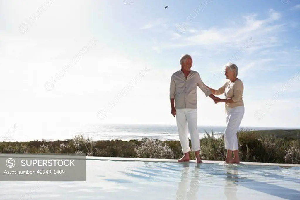 Senior couple by the pool