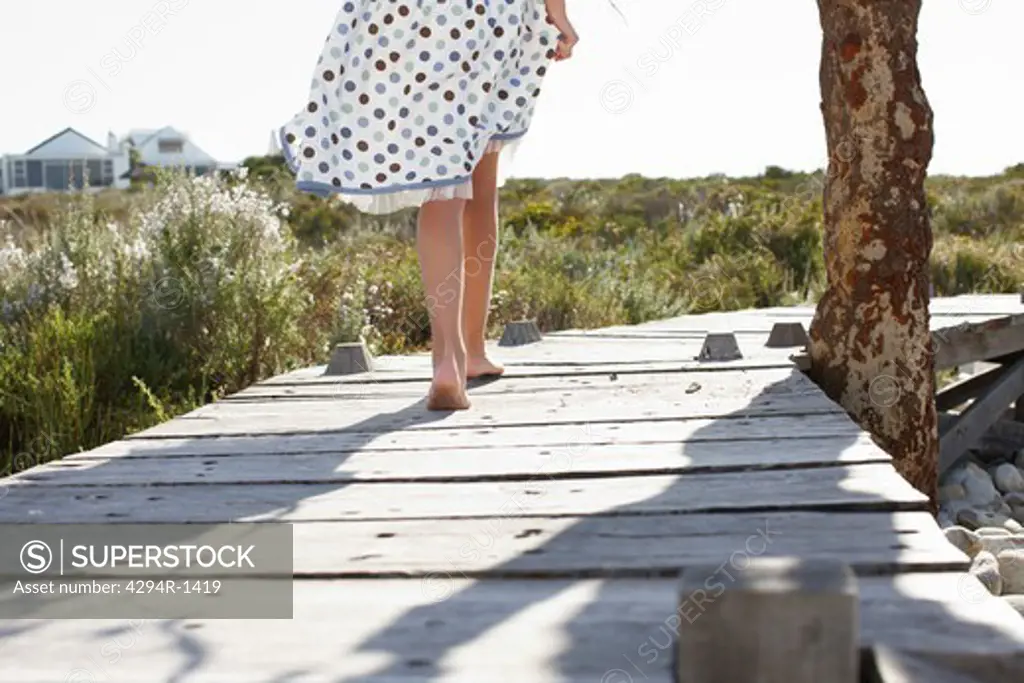 Girl walking on wooden path