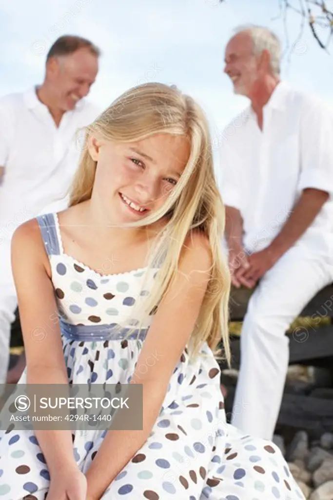 Blond girl with father and grandfather in background