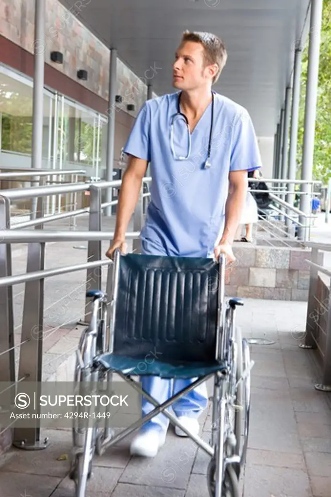 Male nurse pushing wheelchair