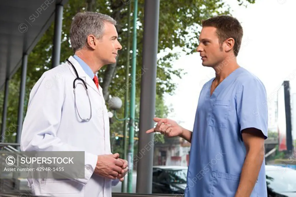 Two doctors talking outside hospital