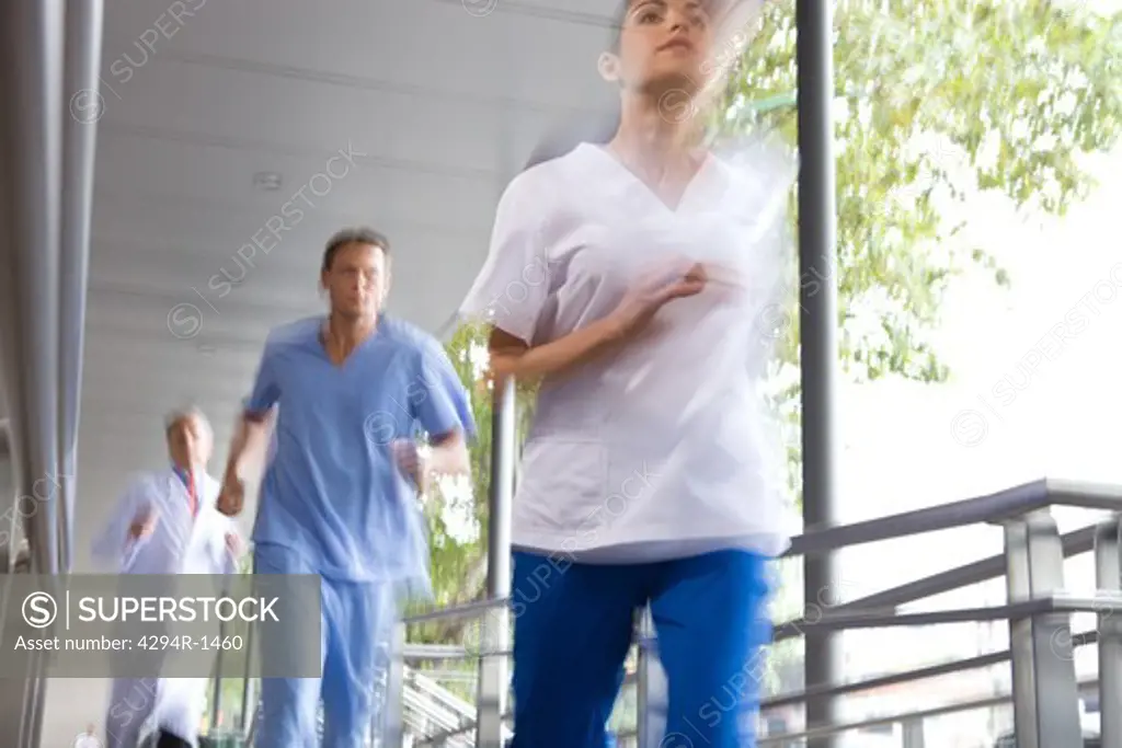 Healthcare workers running outside hospital