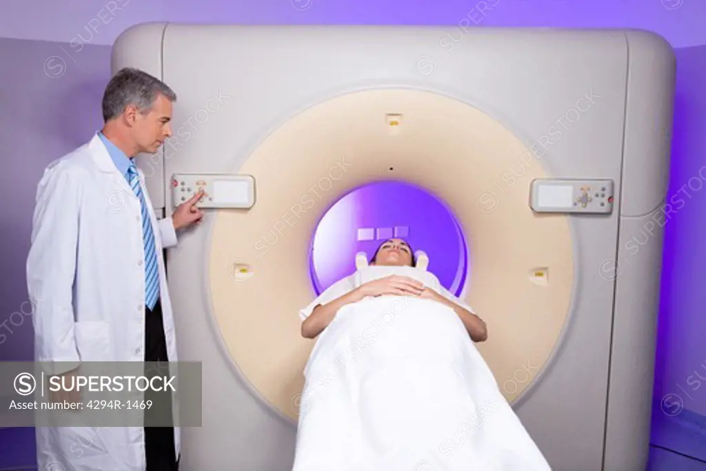 Doctor with patient at CT scanner