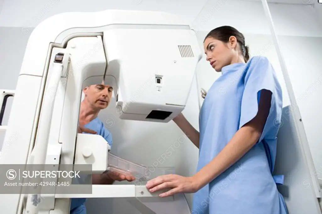 Doctor and patient performing a mammography