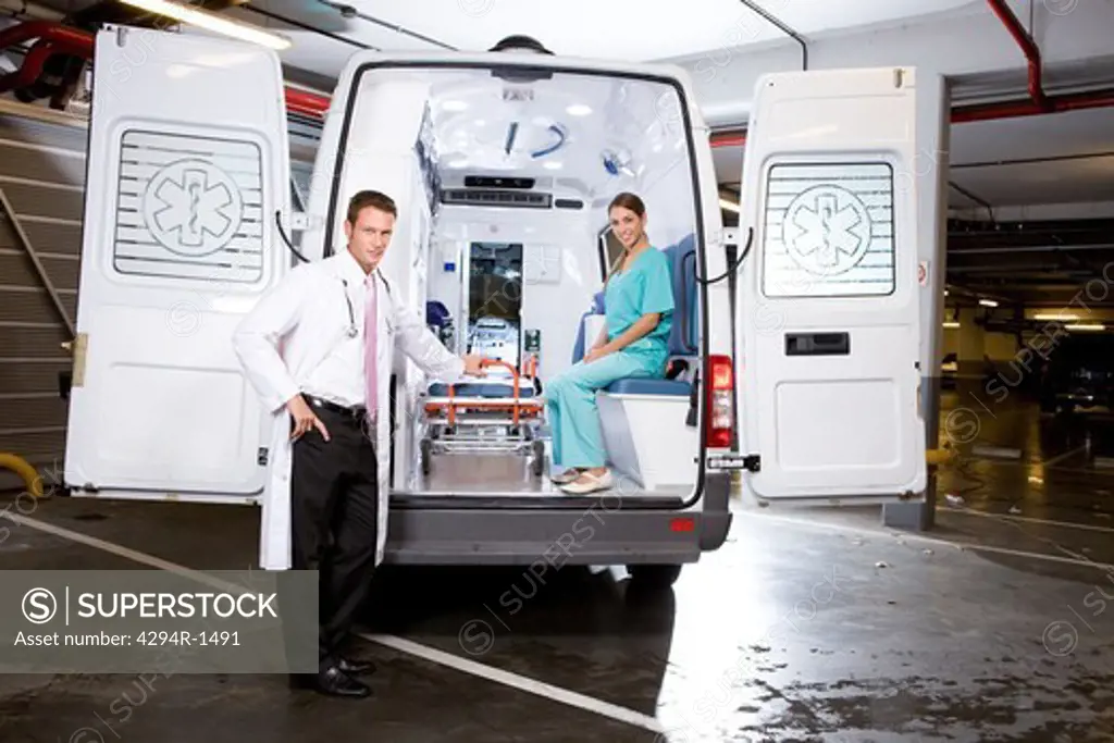 Doctor and paramedic in ambulance car