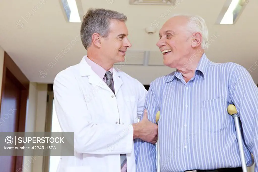 Doctor assisting a disabled senior